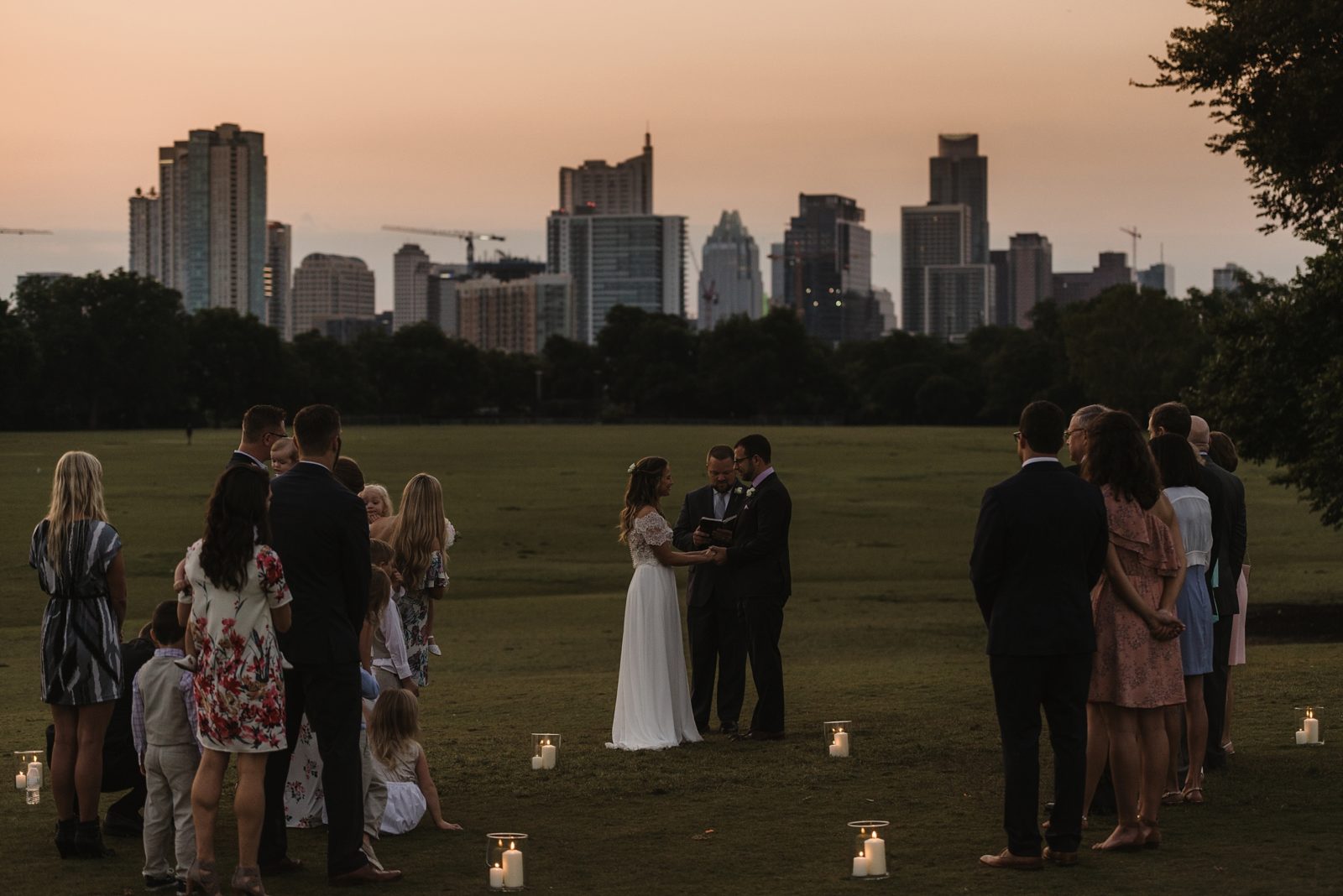 Sunrise, candle-lit elopement in Zilker Park with the Austin skyline in the background