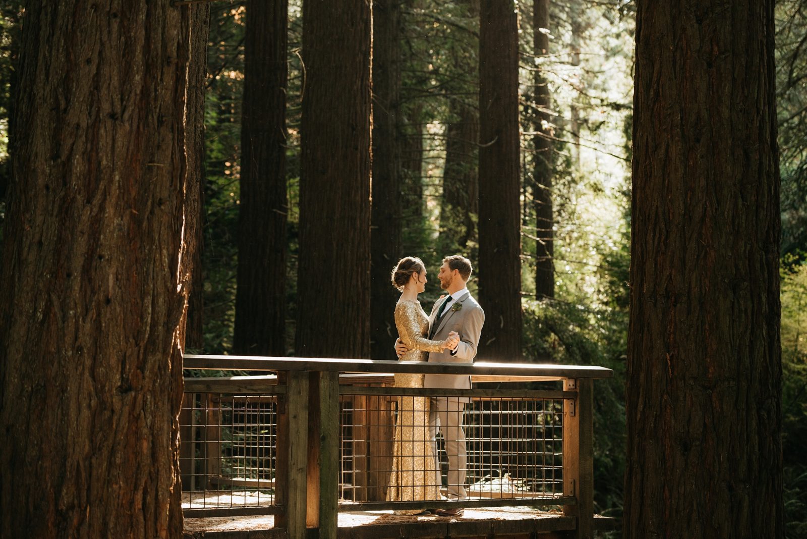 Couple dancing on the redwood deck of Hoyt Arboretum after eloping.