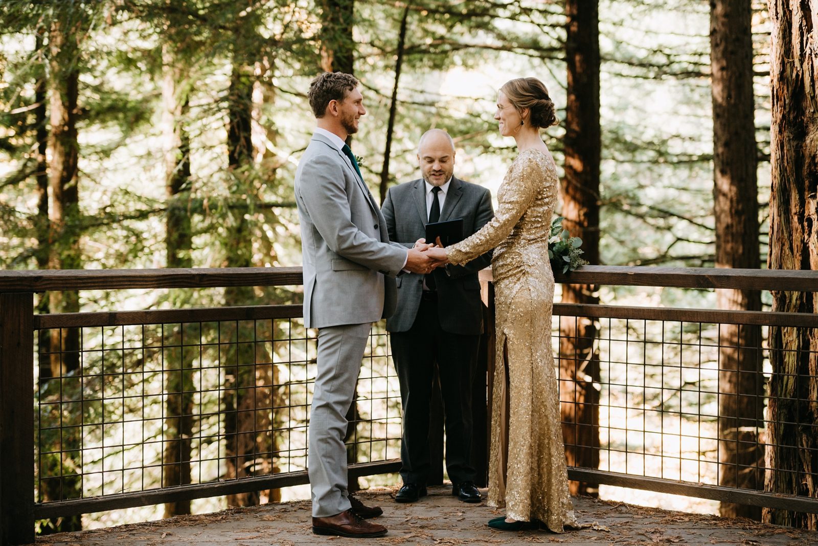 Elopement on the Redwood Deck of Hoyt Arboretum in Portland, Oregon. The bride is wearing an amazing gold, sparkly dress.