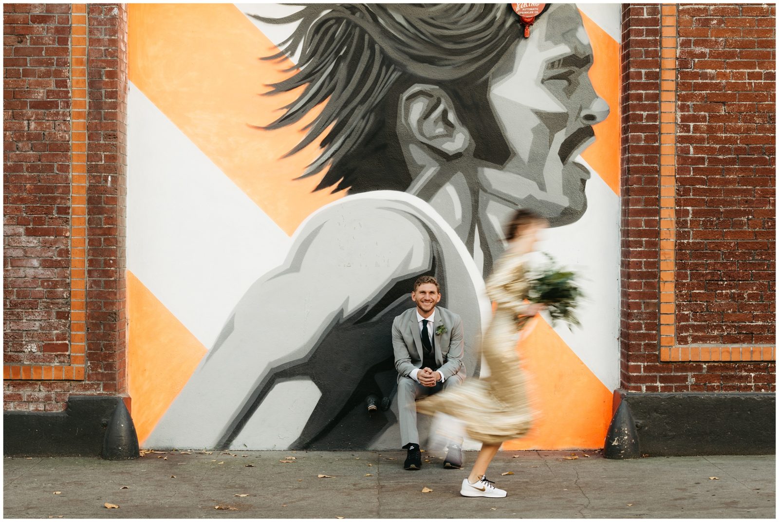 Creative elopement portrait in front of Pre Fontaine mural in downtown Portland, OR