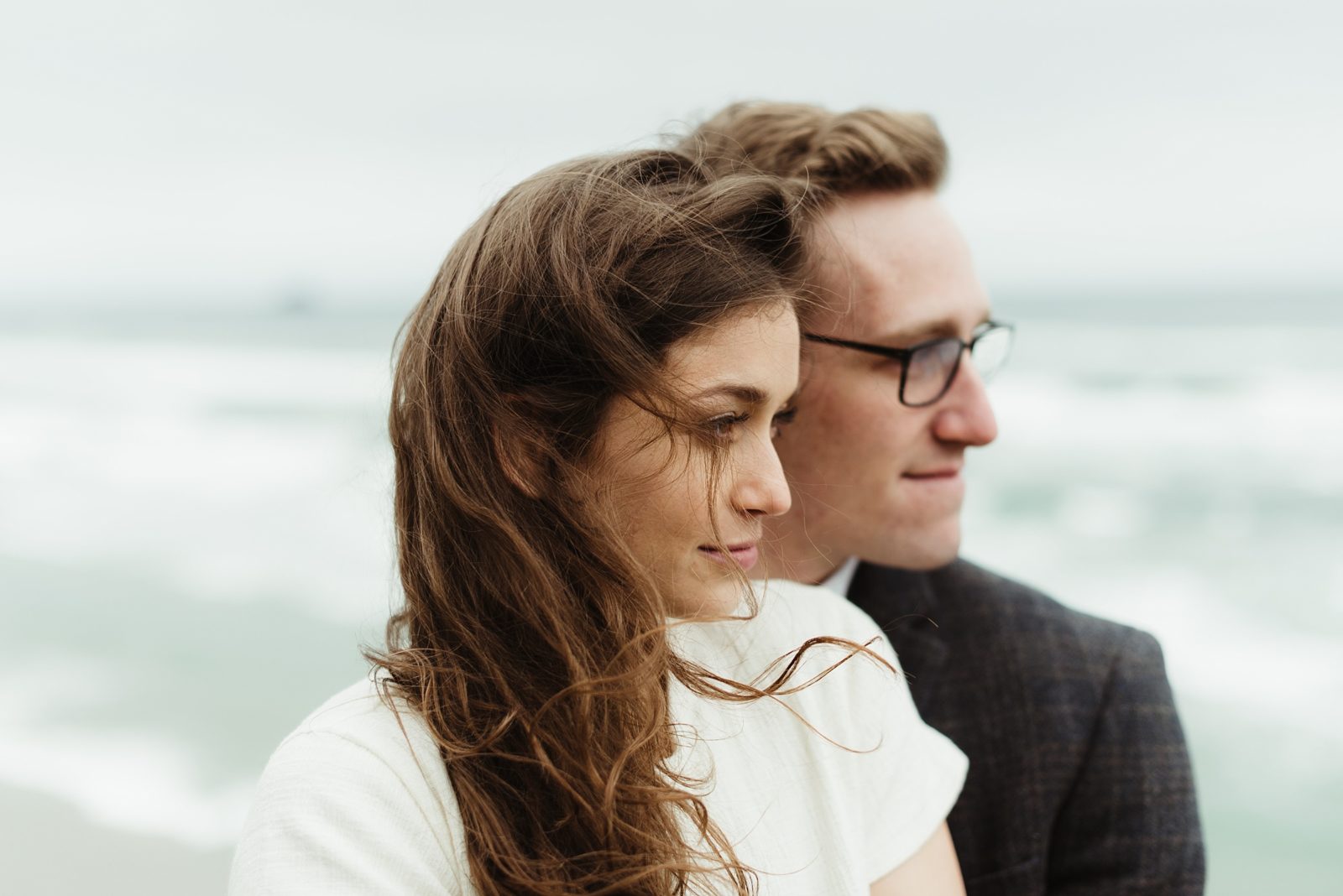 Profile portrait of couple in front of the ocean during engagement shoot at the Oregon Coast