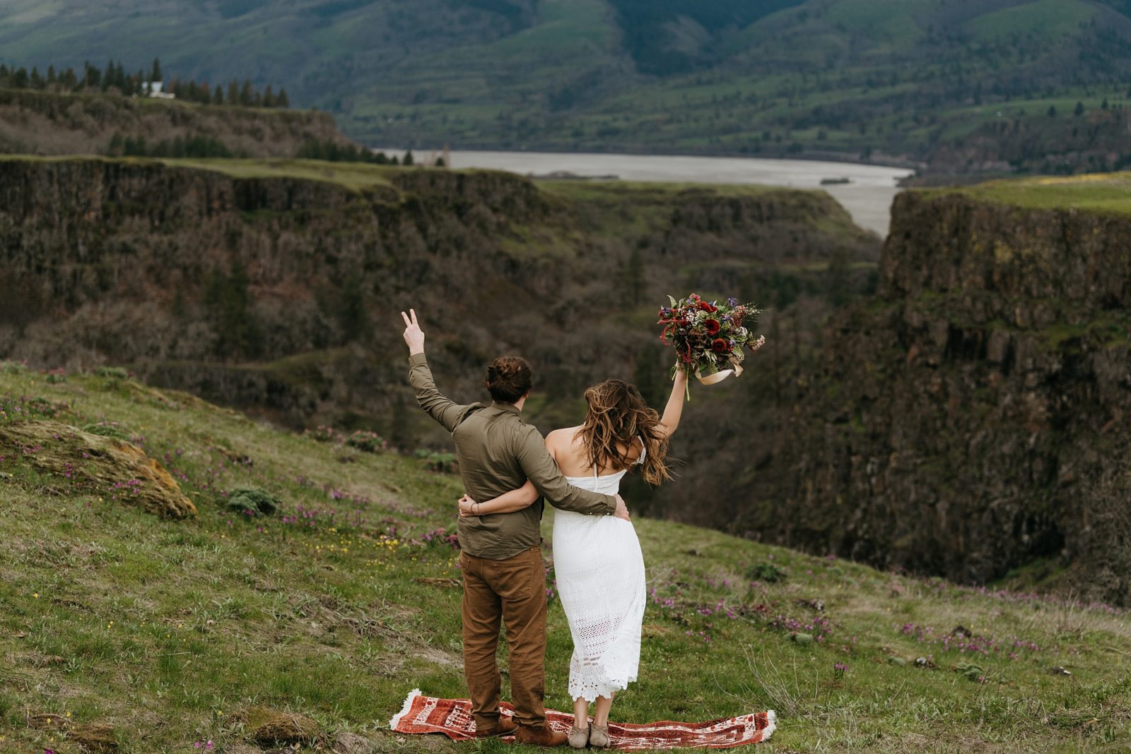 Bohemian elopement with persian rug on cliffside of Rowena Crest in Columbia River Gorge, Oregon.