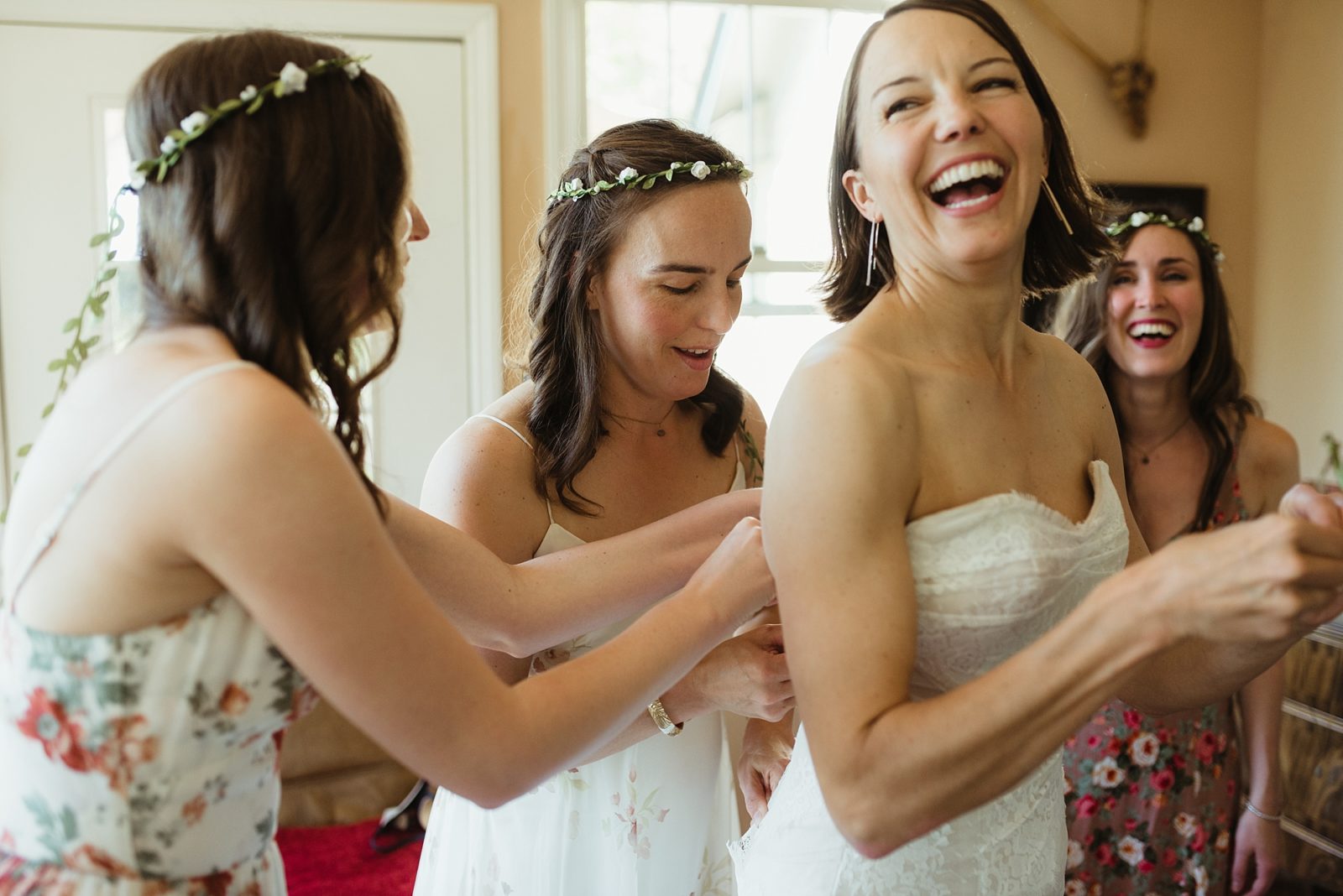 Adorable bridal party getting ready in flower crowns and floral print dresses