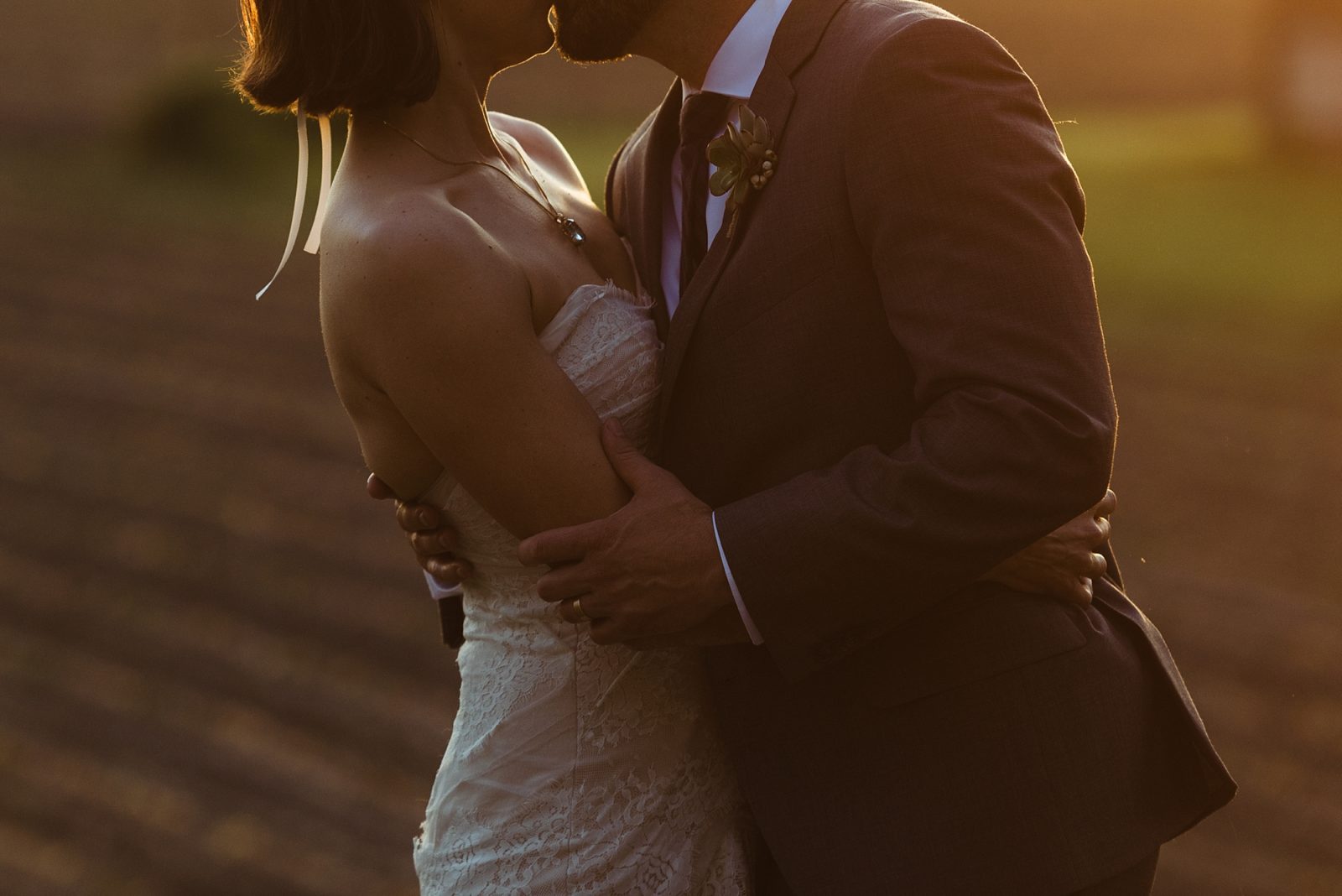 Newly wed couple kissing at sunset during a summer wedding in Washington