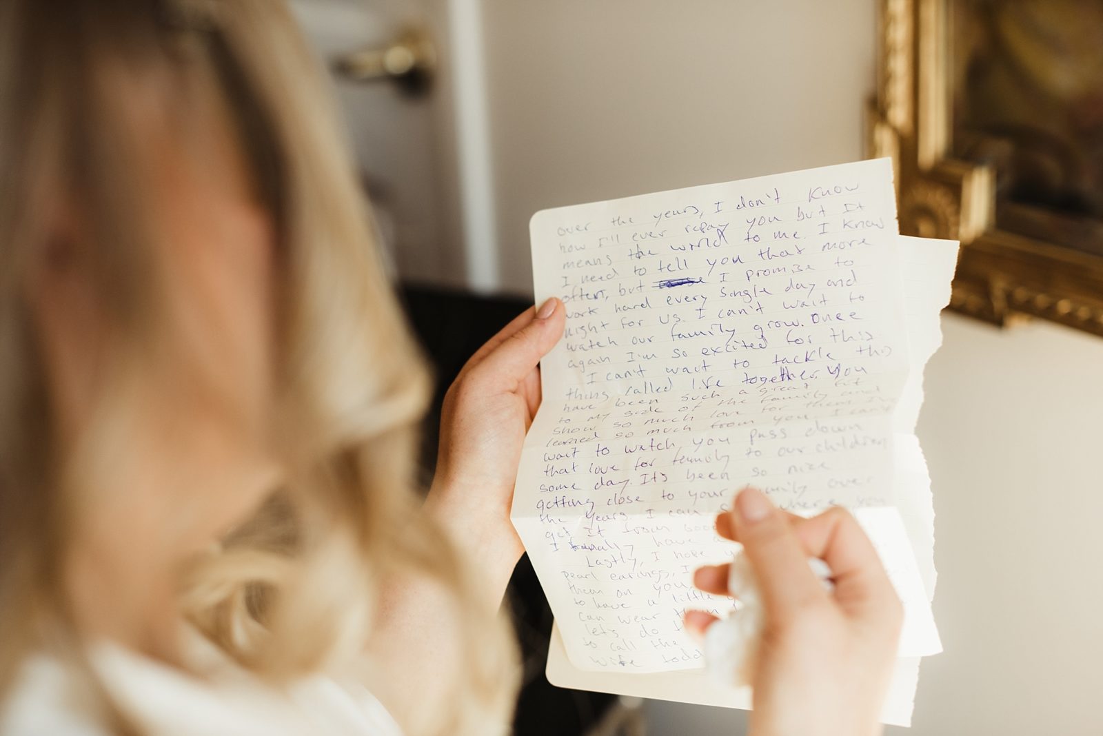 Bride readying sweet note from groom as she get's ready for her wedding.