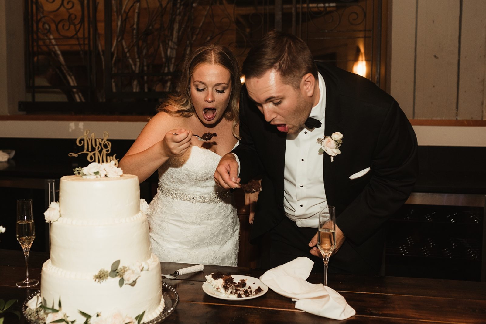 Fun couple cutting and eating their cake at The Foundry by Herban Feast in Seattle