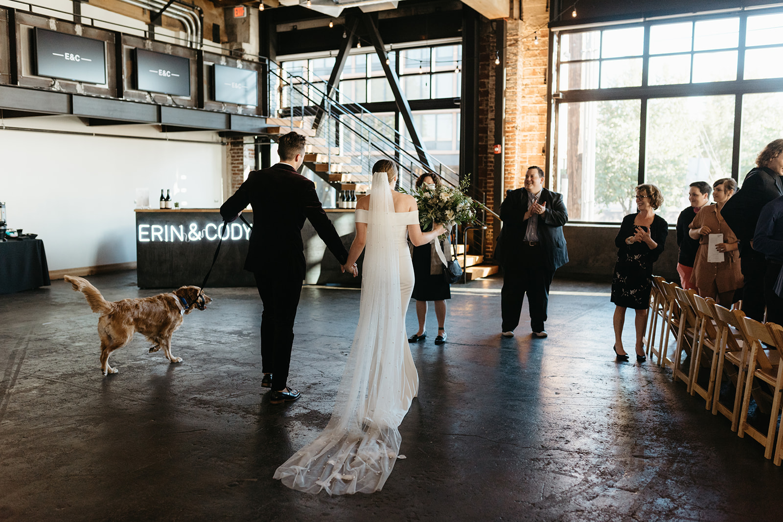 Bride and groom and their dog during indoor wedding ceremony at Leftbank Annex