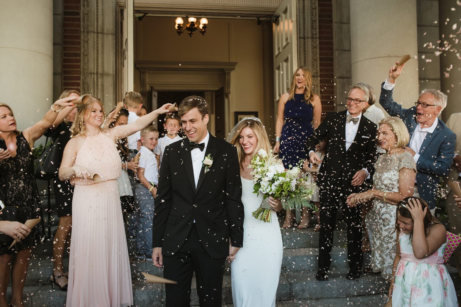 Fun confetti exit of a modern and stylish church wedding ceremony in downtown Portland, Oregon.